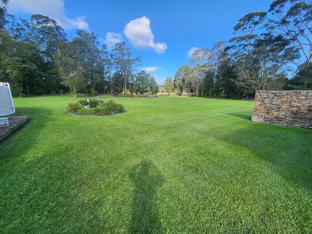 Large acreage lawn with garden feature and stone shed